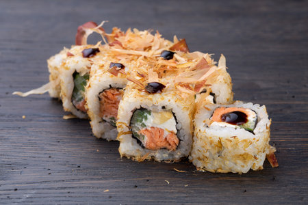 traditional Japanese sushi with salmon, soft cheese, avocado and tuna, garnished with sauce. Japanese kitchen. Japanese restaurant.の写真素材