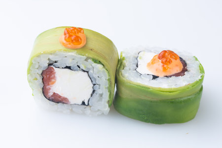 traditional Japanese cuisine. japanese sushi isolated on white background. maki sushi with baked salmon, avocado, soft cheese (Philadelphia). green sushiの写真素材