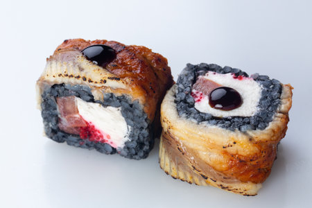 traditional Japanese cuisine. japanese sushi isolated on white background. maki sushi with eel, tomato, soft cheese (Philadelphia) and red caviar. black sushiの写真素材