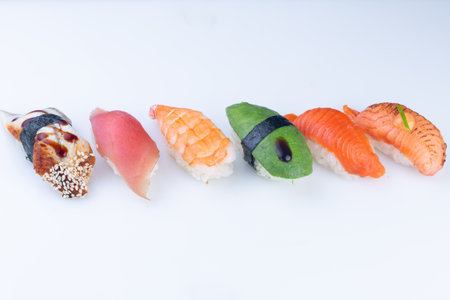 Set Nigiri sushi set of tuna, salmon, shrimp, sea bass, avocado. Nigiri sushi collection on white background, reflection, high resolutionの写真素材