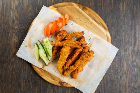deep-fried chicken nuggets breaded with fresh cucumber and tomato. beer snack. view from aboveの写真素材