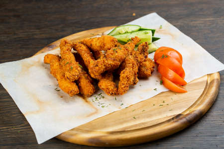 deep-fried chicken nuggets breaded with fresh cucumber and tomato. beer snack.の写真素材