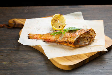 whole baked fish in foil with lemon. fried bassの写真素材