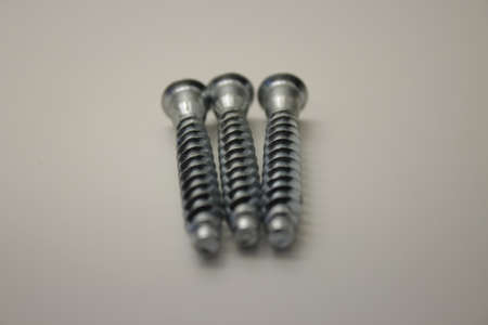 screws and nuts for furniture on a white backgroundの写真素材