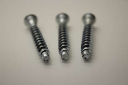 screws and nuts for furniture on a white backgroundの写真素材