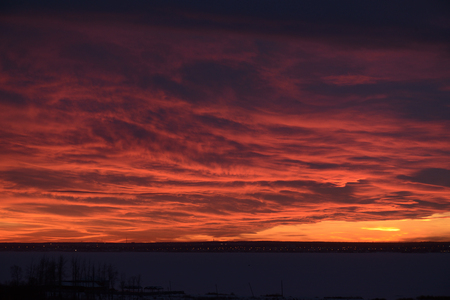sunset over the lake, red clouds. winter landscapeの写真素材