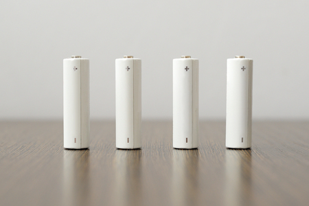 four AA batteries on the table upright standの写真素材
