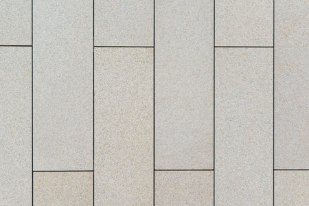 wall of rectangular slabs of light limestone
