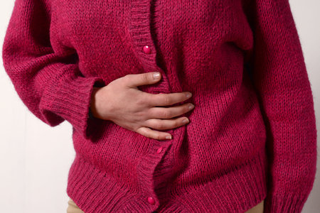 closeup photo. a woman has a pain in her stomach, and holds her hands. Concept of female medicine....