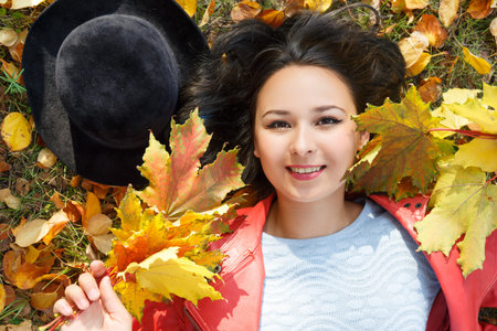 autumn concept portrait of a girl woman in a hat and red jacket
