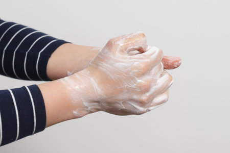 Hand washing with antibacterial soap. Prevention of coronavirus. Close-up.