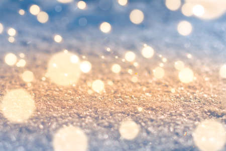 Macro texture of the snow surface with bokeh highlights and fabulous lighting effect. With a place for the inscriptionの写真素材