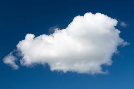 A white cumulus cloud against a dark blue daytime sky. A high resolution. sample for copying.の写真素材
