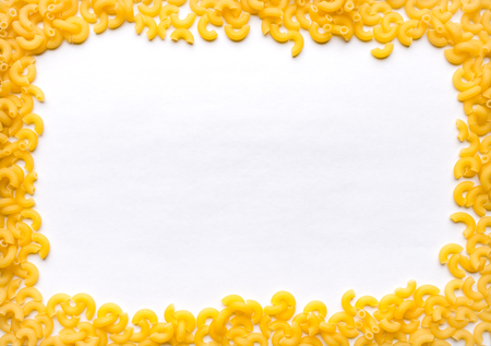 Macaroni frame on a dark wooden tableの写真素材