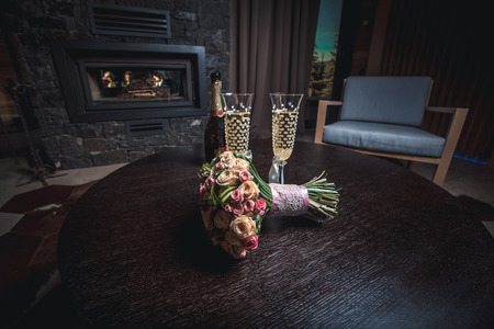 Bride bouquet with glass of champagneの写真素材