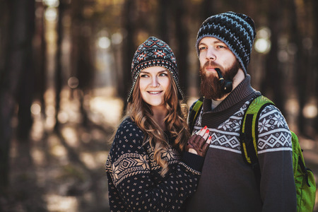 Outdoor happy couple. The bearded guy with tobacco pipeの写真素材