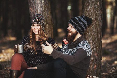 Outdoor happy couple. The bearded guy with tobacco pipeの写真素材