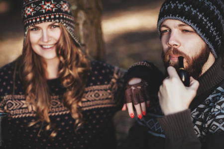 Outdoor happy couple. The bearded guy with tobacco pipeの写真素材