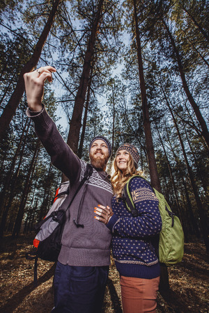 Happy young couple of tourists and taking selfieの写真素材