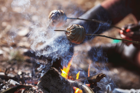 Marshmallow on a stick roasted over a camping fireの写真素材