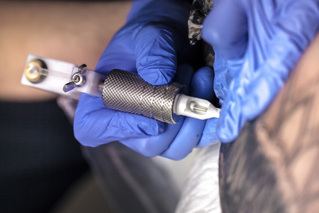 Tattooist makes a tattoo. Closeupの写真素材