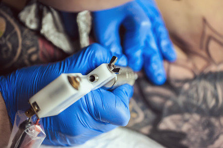 Tattooist makes a tattoo. Closeupの写真素材