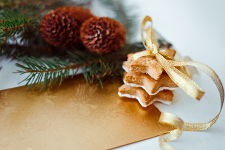 Christmas cookies with festive decoration and twigs of Christmas treeの写真素材