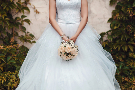 Beautiful wedding bouquet in hands of the brideの写真素材