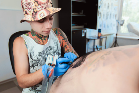 Tattooist makes a tattooの写真素材