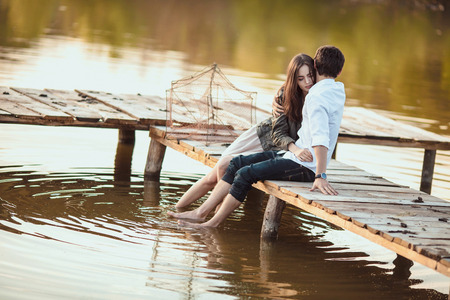 Couple on the wooden jetty at a lakeの写真素材