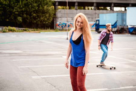 Young couple are holding skateboard outsideの写真素材
