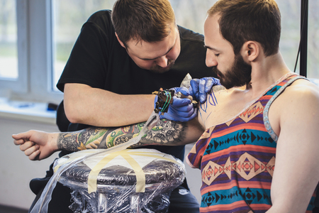 Tattooist makes a tattoo. Closeupの写真素材
