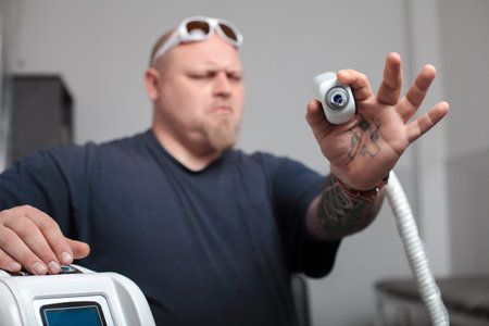 The professional machine for removal of tattoos with master