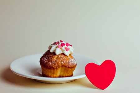 Beautiful red heart and cupcake on a platter on the table