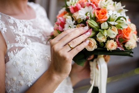 Beautiful wedding bouquet in hands of the brideの写真素材