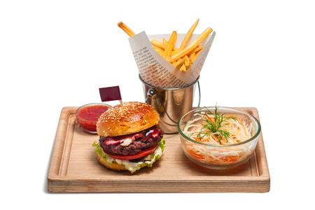 fast food and unhealthy eating concept - close up of hamburger or cheeseburger, deep-fried french fries, pizza and ketchup on wooden table top viewの写真素材