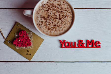 Beautiful coffee Cup with heart cupcake on white wooden backgroundの写真素材