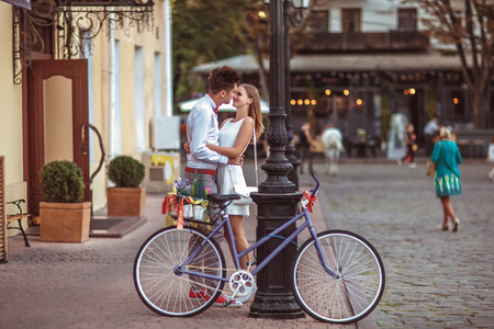 Summer holidays, bikes, love, wedding- couple with bicycles in the city.の写真素材