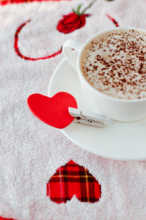 Beautiful coffee Cup with heart on a white wooden backgroundの写真素材