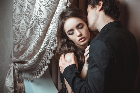 Young beautiful pair of lovers hug and kissの写真素材