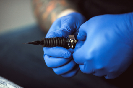 master tattoo artist prepares tools for tattooingの写真素材