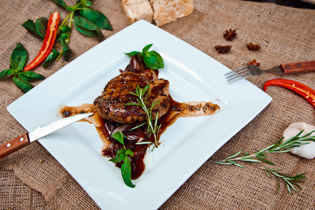 Beautiful juicy pork steak cooked on the grill with caramelized onionsの写真素材