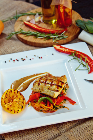 Baked perch fillet with rosemary and lemon with blanched vegetablesの写真素材