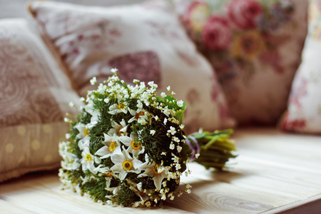 Beautiful and original bouquet of flowers lying on the windowsillの写真素材