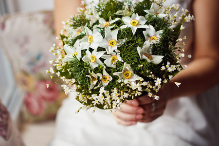 Beautiful and original bouquet of flowers in the hands of a girlの写真素材