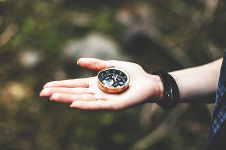 Man holding a compass.The concept of navigation, leisure.の写真素材