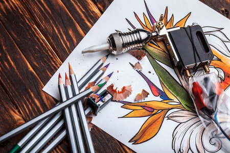 beautiful sketch drawing flowers with colored pencils lying on old wooden backgroundの写真素材