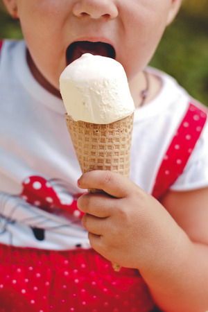 Beautiful young girl eating tasty ice creamの写真素材