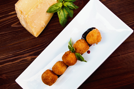 Cheese croquettes (Cheese breaded Camembert with berry sauce)の写真素材