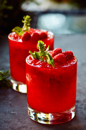 alcoholic cocktail Raspberry cobbler with mint leaves on a dark backgroundの写真素材
